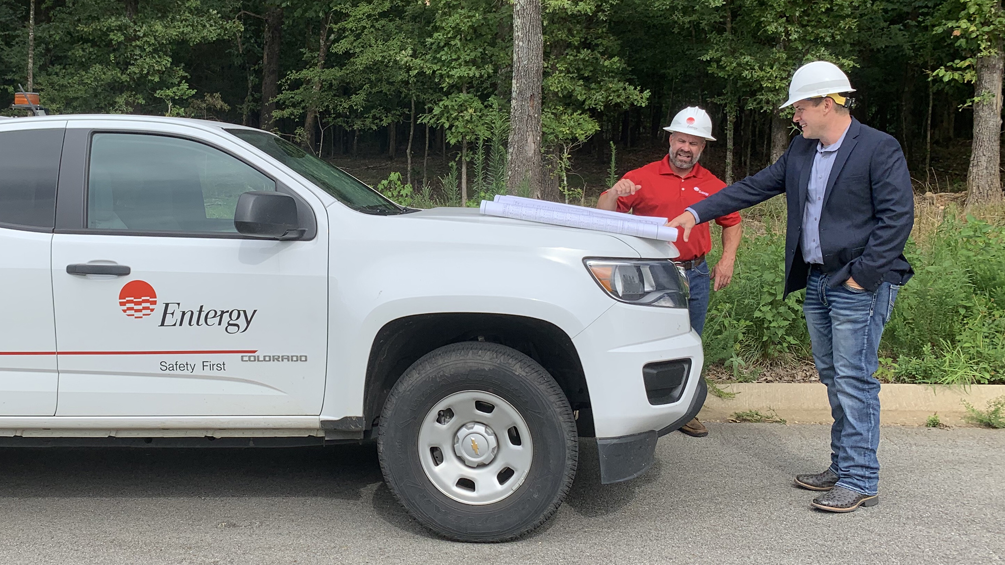 Entergy Arkansas Line Supervisor Chris Stone (left) and Customer Service Manager Matt Faries (right) discuss a major project to upgrade Entergy’s facilities that serve the Riverbend Park area in Hardy.